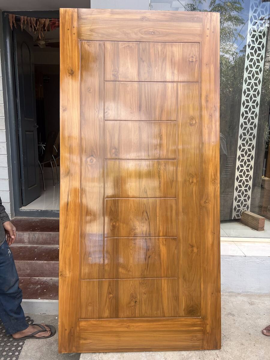 Custom panelled teak door from a supervised installation project