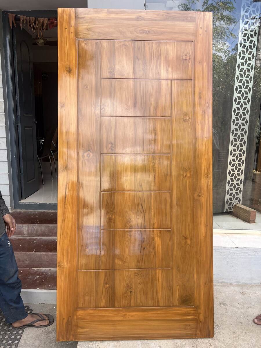 Custom panelled teak door from a Sri Shiva Saw Mills supervised project